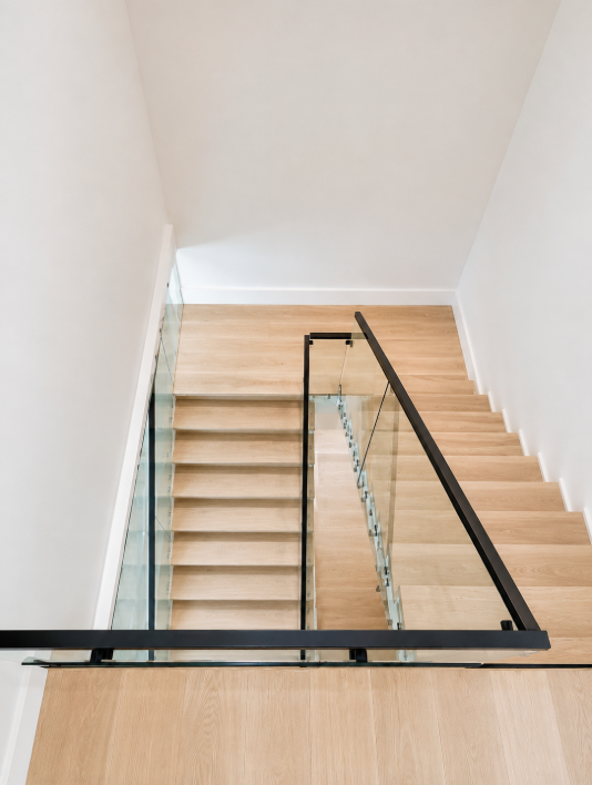 Modern glass railing on a lakeside deck