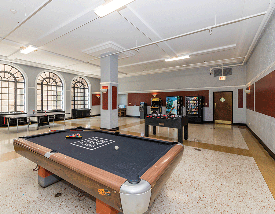 There is a pool table in the middle of the room.