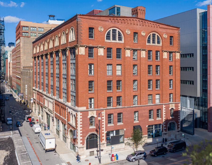 An aerial view of a large brick building in a city