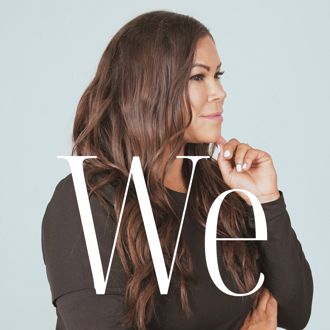 Woman with long brown hair, wearing black, looking to the side with hand on chin, light blue background, text “We.”