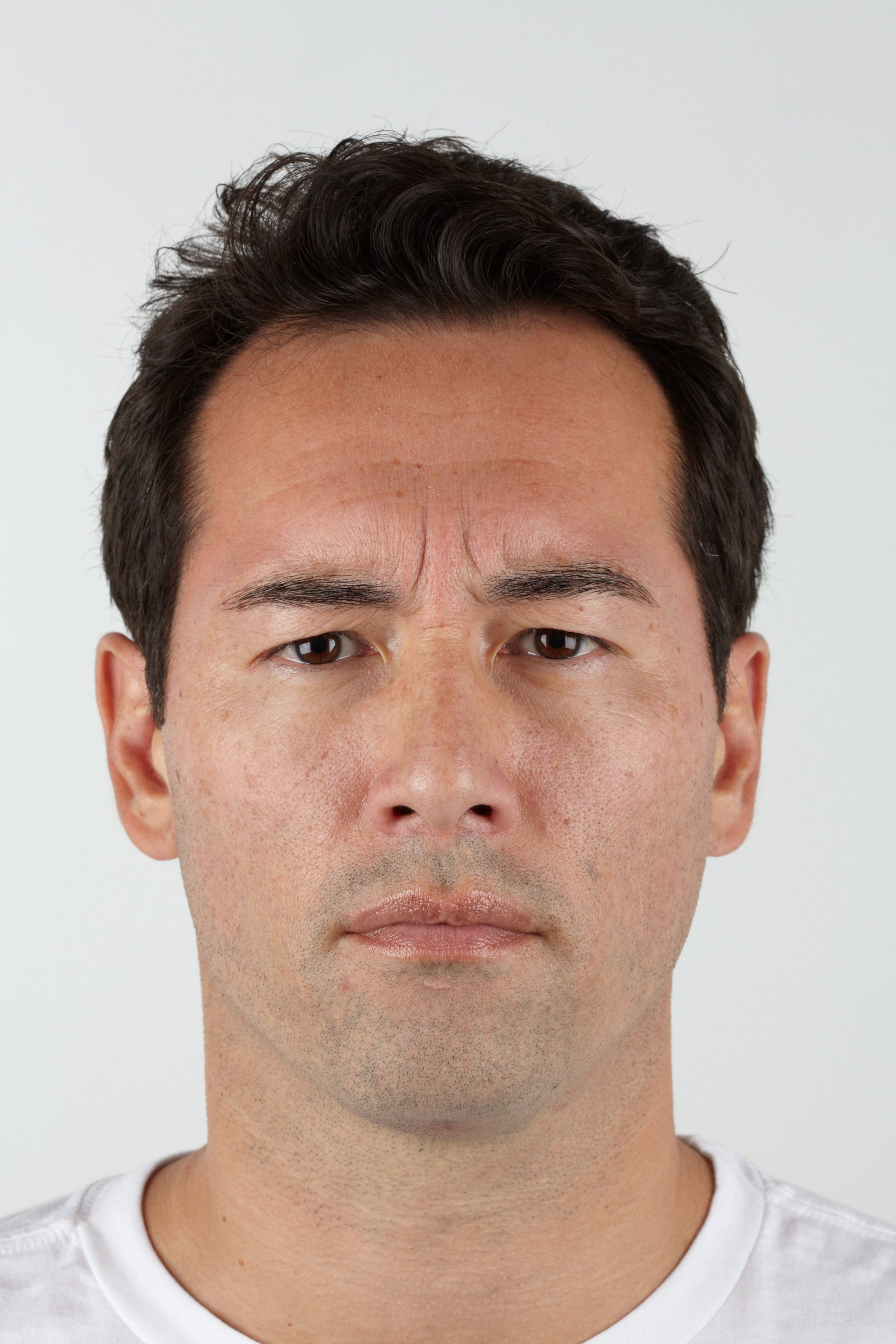 Man with furrowed brow, looking concerned.
