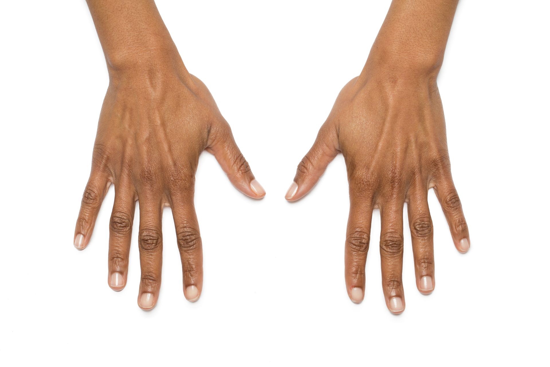 Two hands, dark skin, palms facing up on white background.
