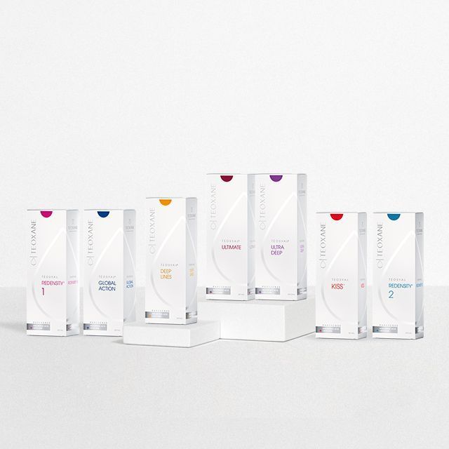 Multiple boxes of skincare products, each with a different color and label, arranged on a white surface.
