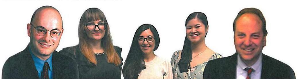 A group of people are standing next to each other and smiling.