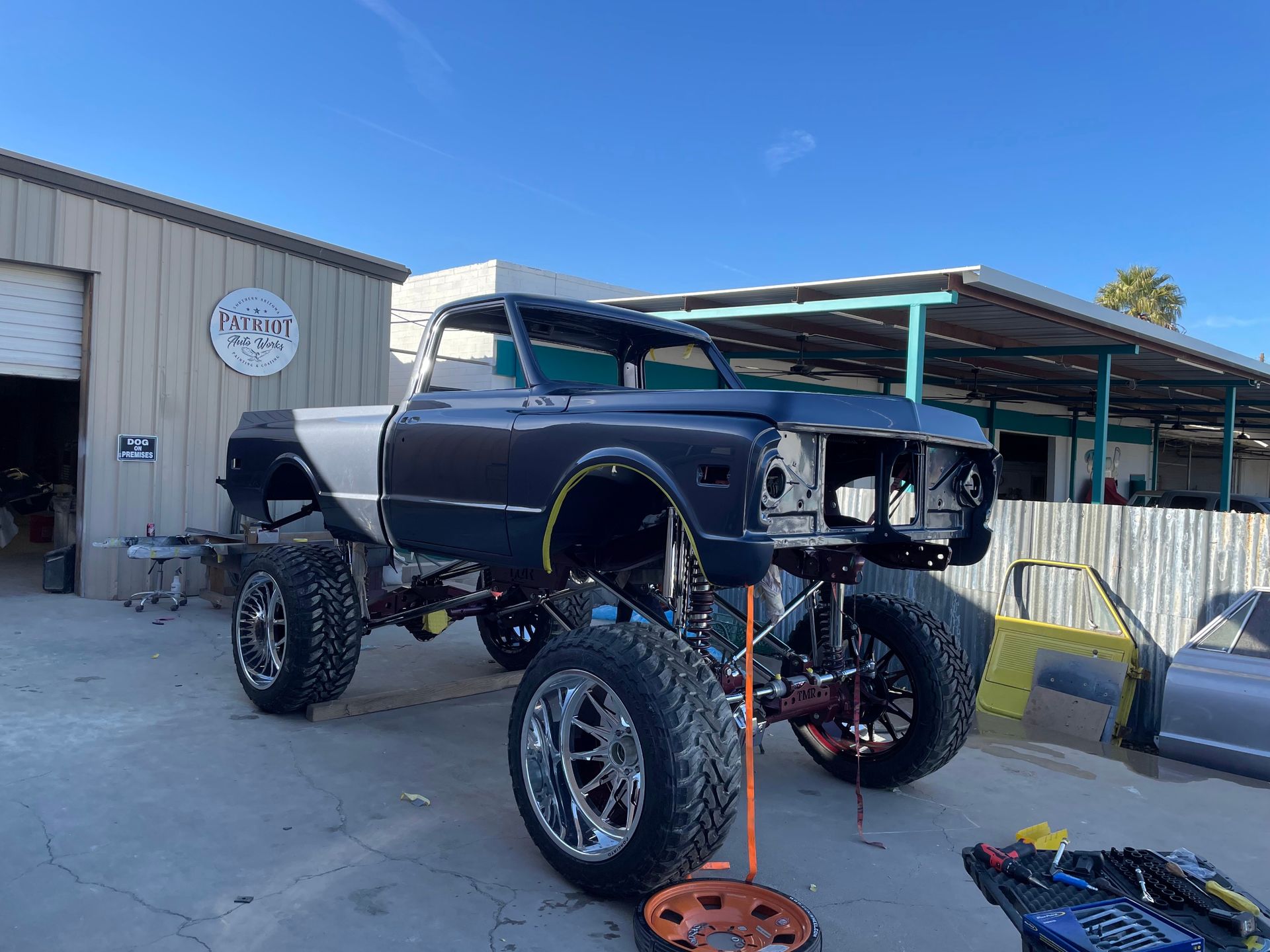 A truck is being built in front of a building.