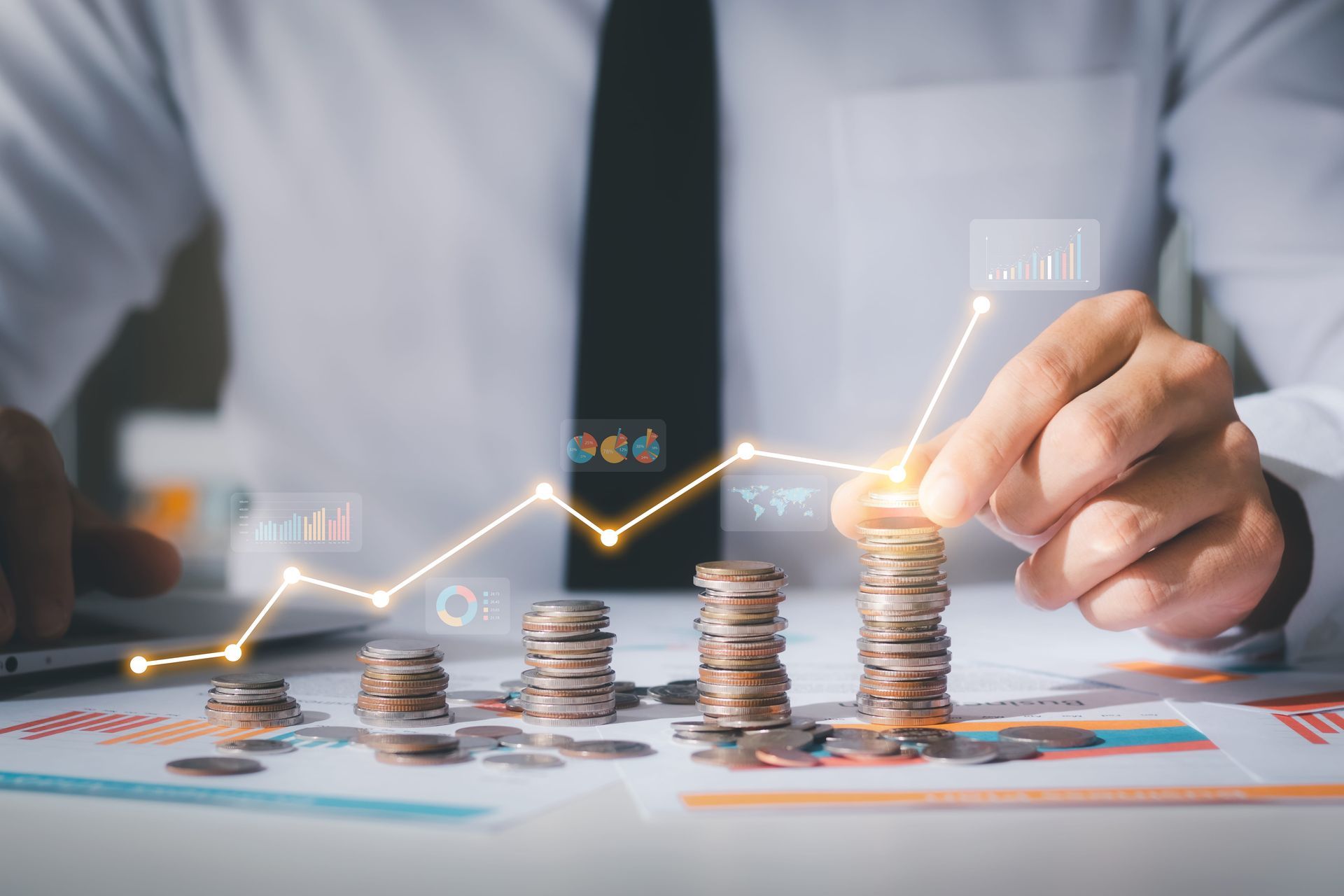 Person stacking coins with a glowing upward trend line, symbolizing financial growth.