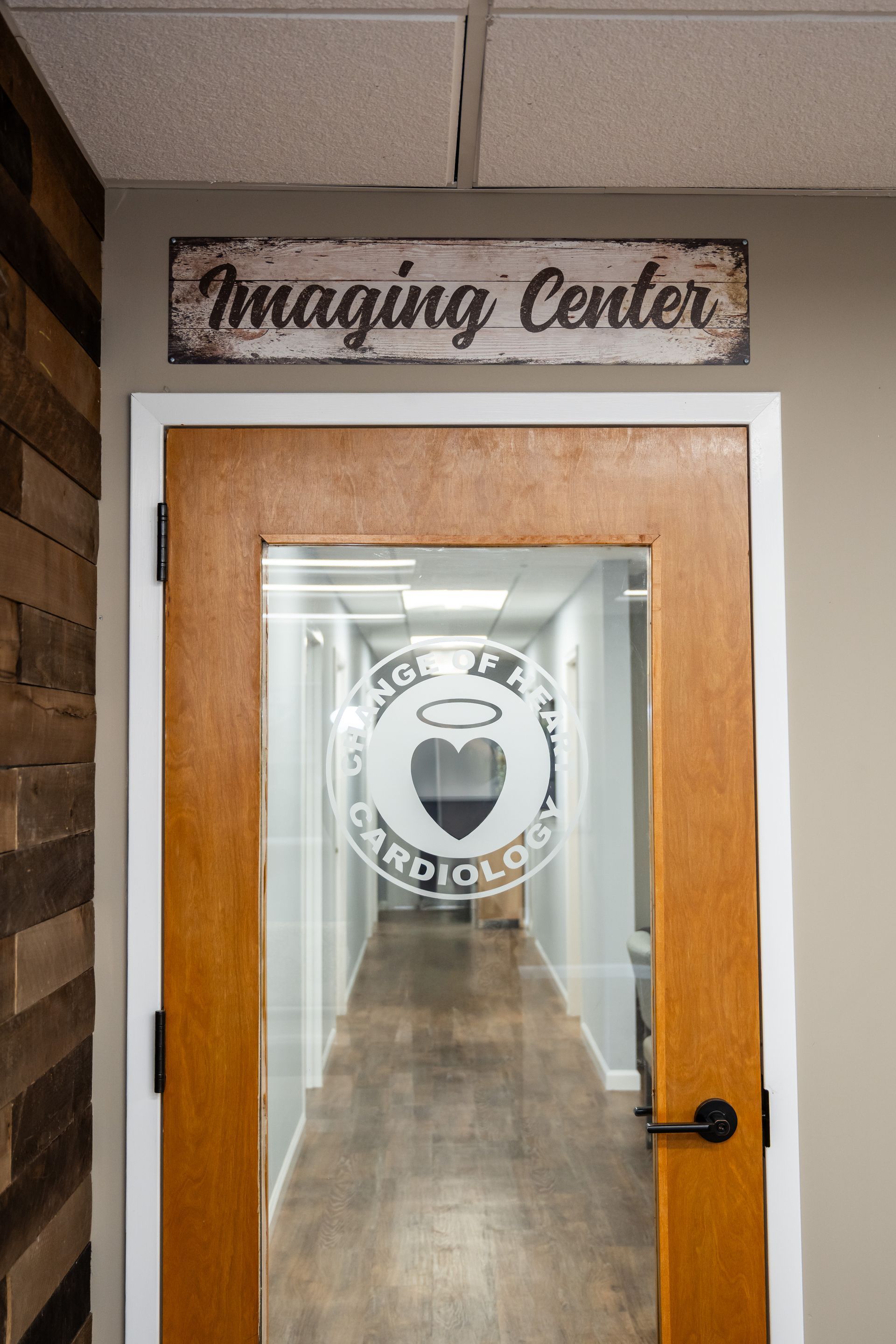 Door to an imaging center with signage above. Long hallway visible through the glass door.