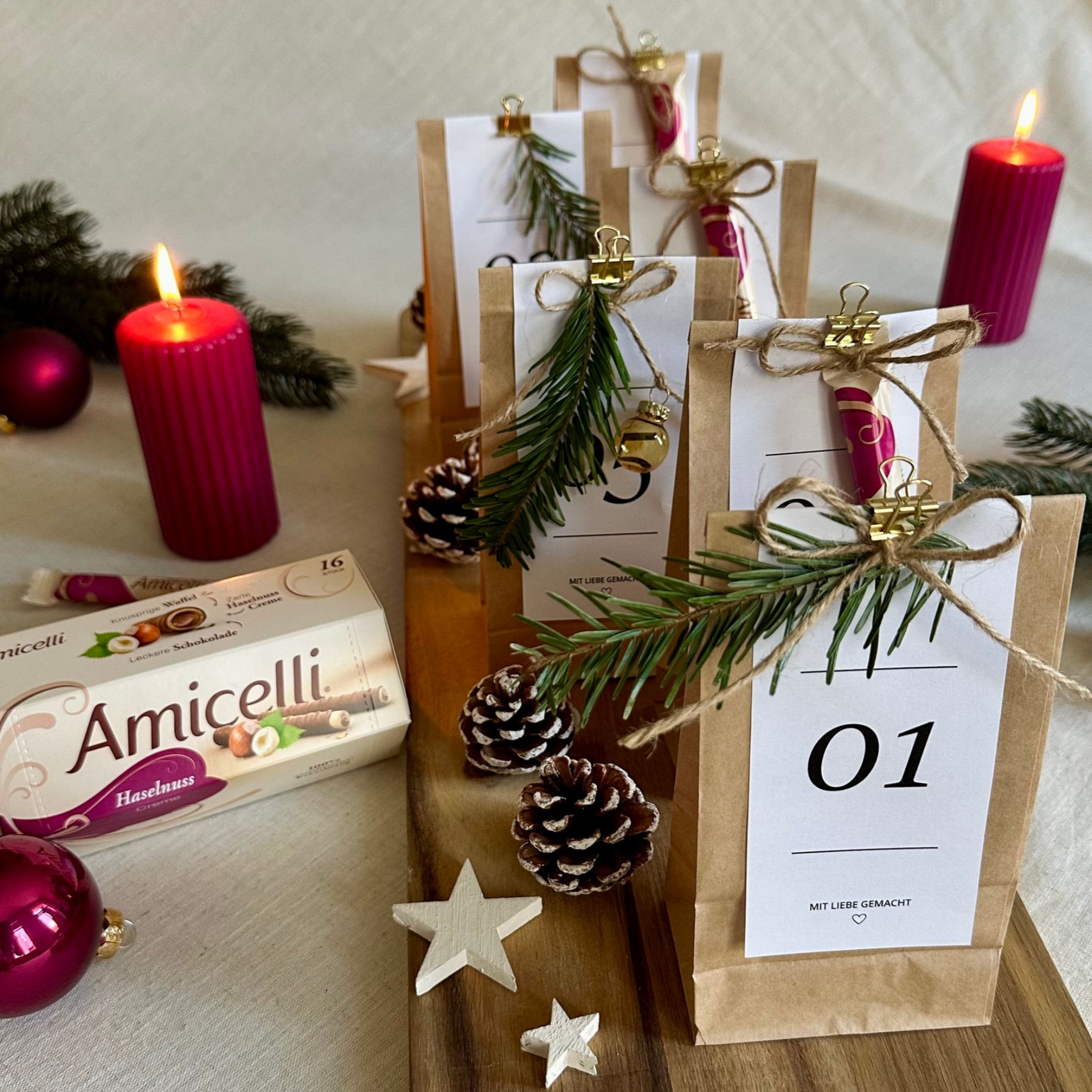 A box of amicielli sits on a table next to a vase of paper flowers