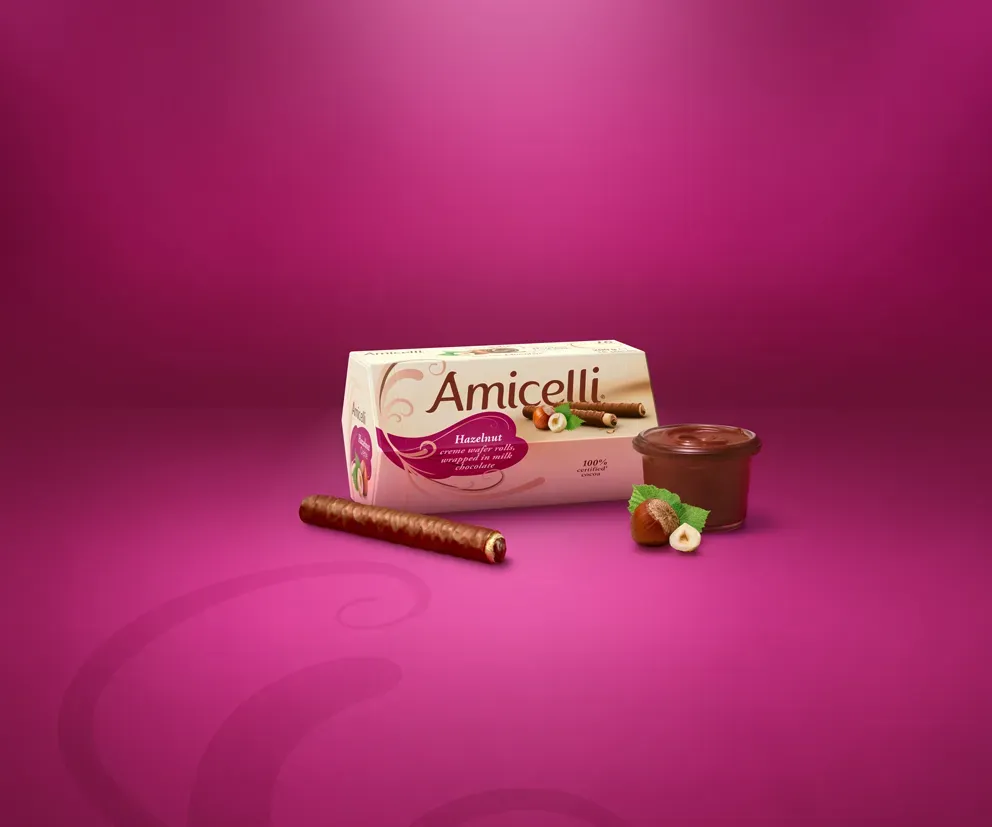 Amicelli box, with chocolate wafers on a pink background, with a glass of hazelnutcreme