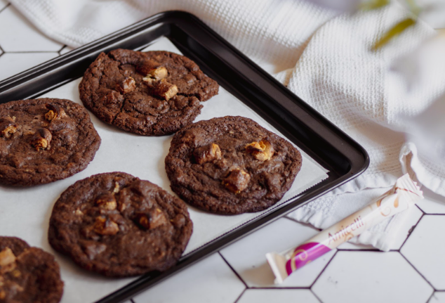 A tray of chocolate cookies is sitting on a table.