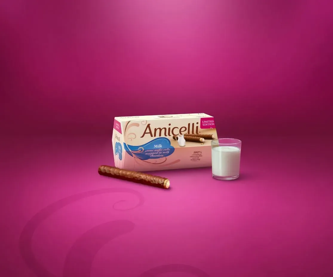 A box of amicelli cookies and a glass of milk on a pink background.