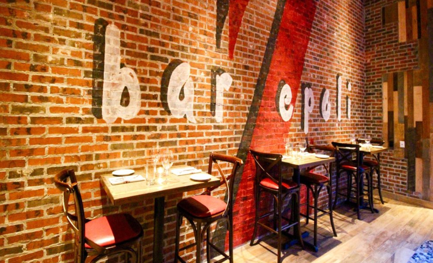 Restaurant interior with exposed brick wall;