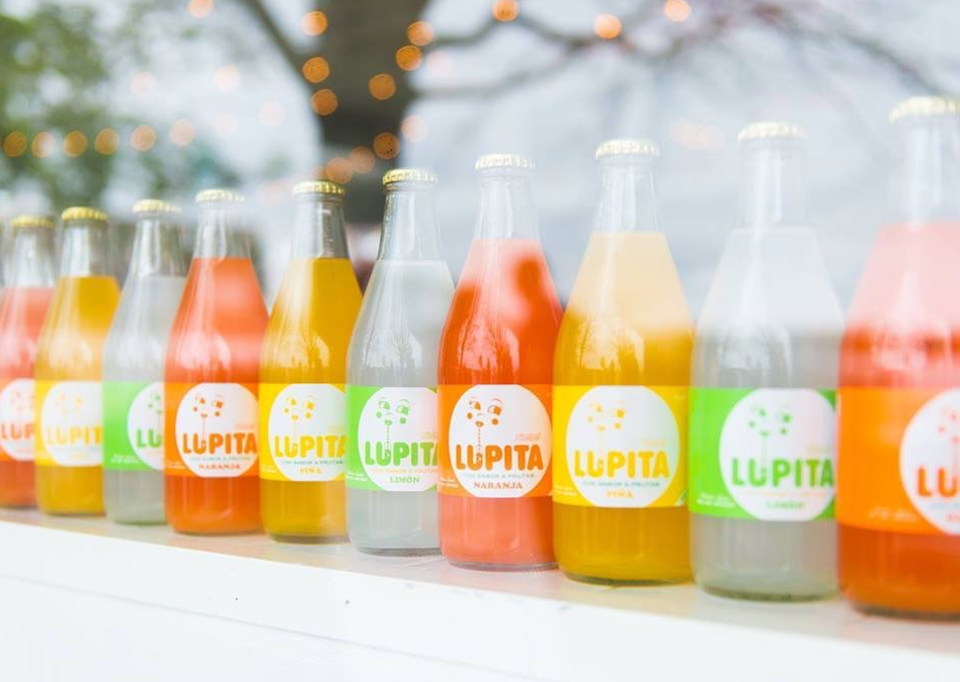 Bottles of colorful juice in a row with 