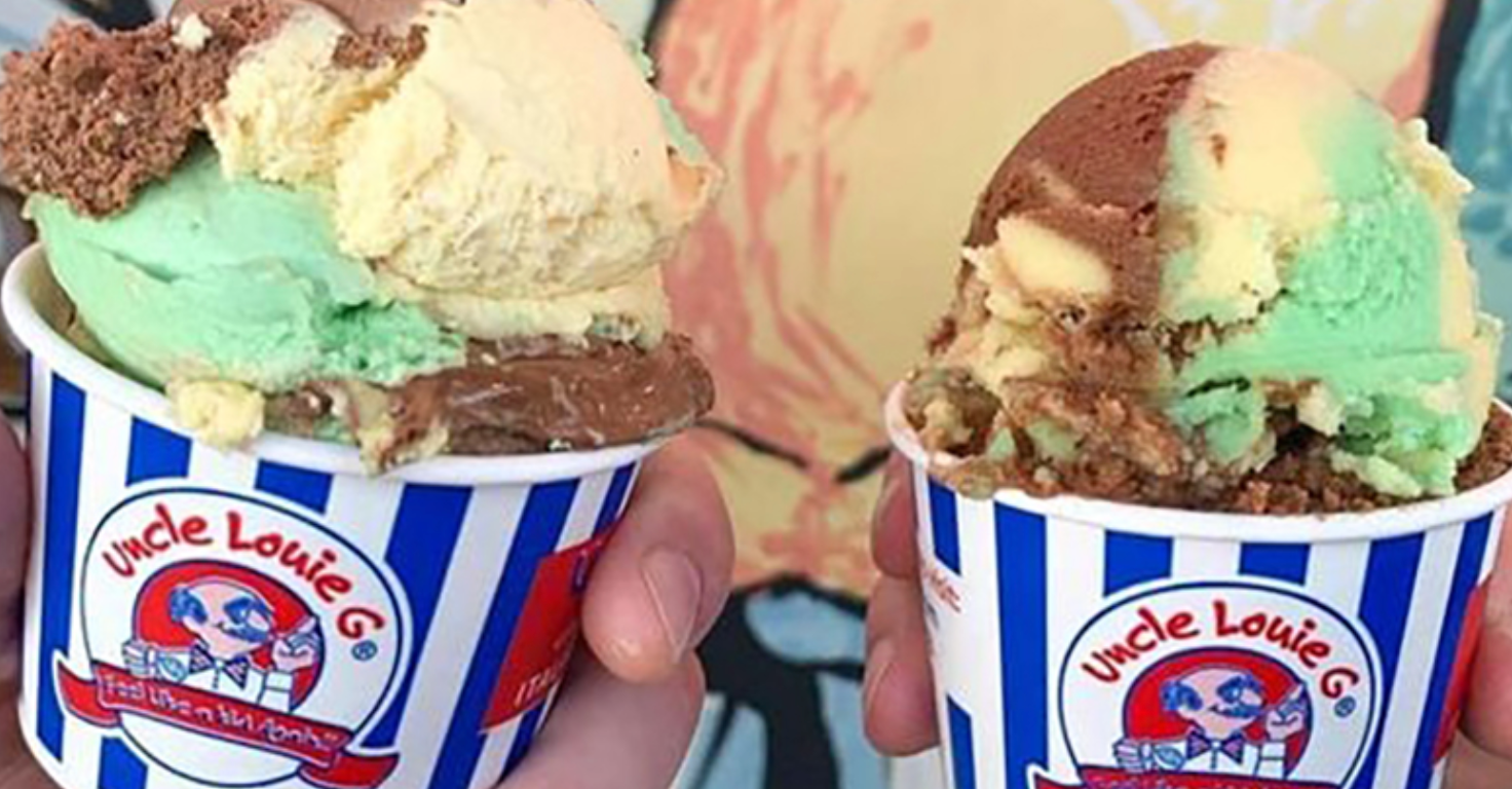 Two ice cream cups with various flavors: mint, chocolate, vanilla. Held by a person.