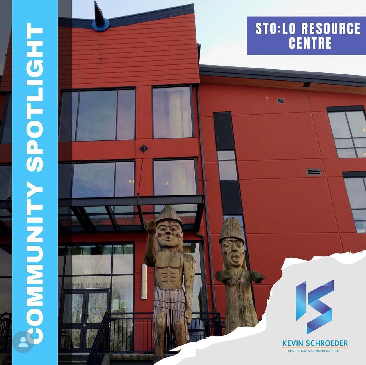 Red building with large windows and totem-like sculptures. 