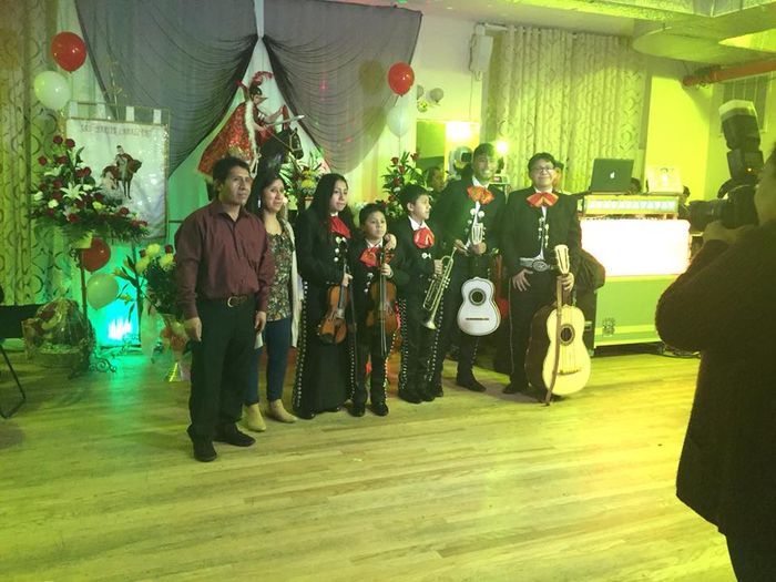 band members taking a picture after a performance with their family