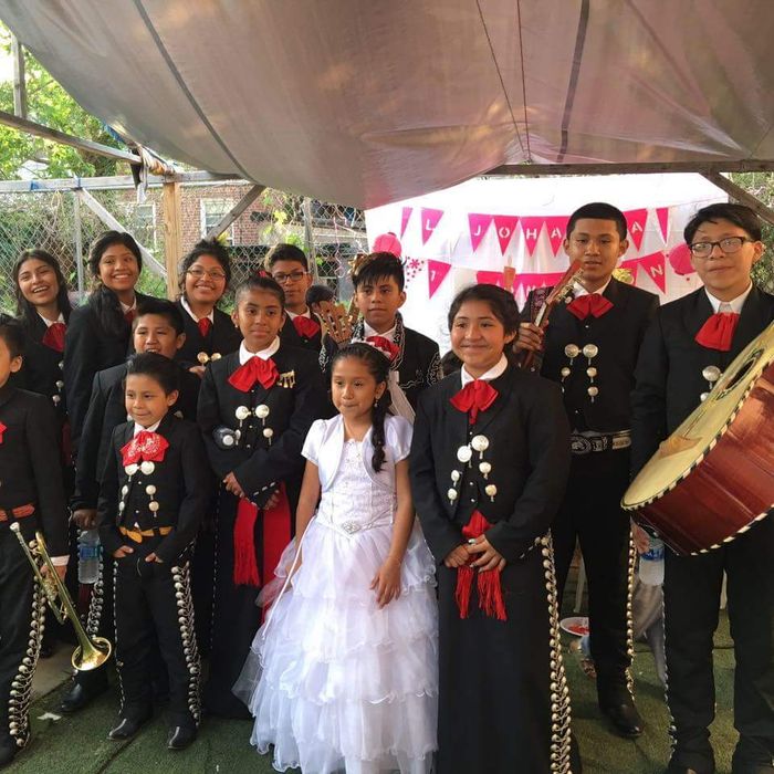 smiling young band members taking a picture after a performance