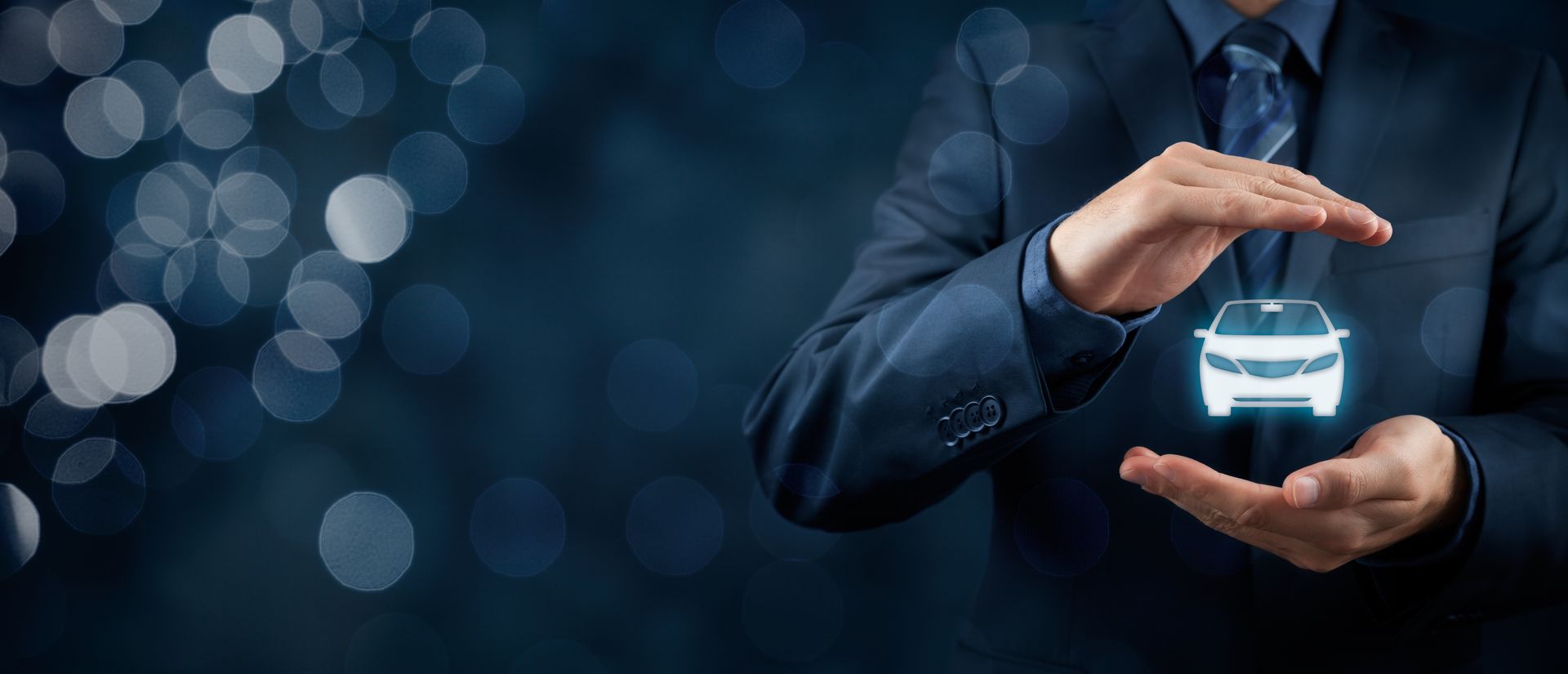 Businessperson shielding a glowing car icon, symbolizing auto insurance protection.