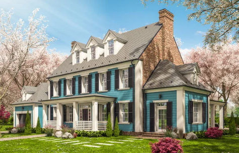 Blue colonial house with black shutters, a brick chimney, and a green lawn under a blue sky.