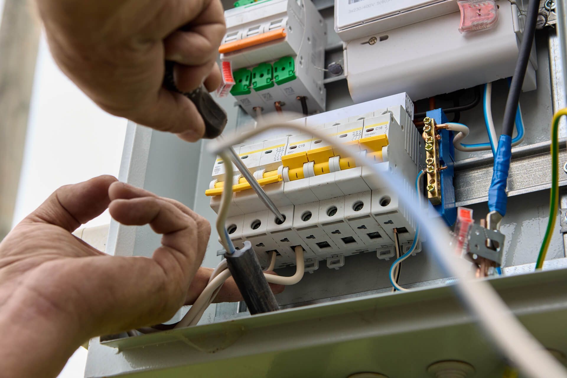 Working on An Electrical Box with A Screwdriver