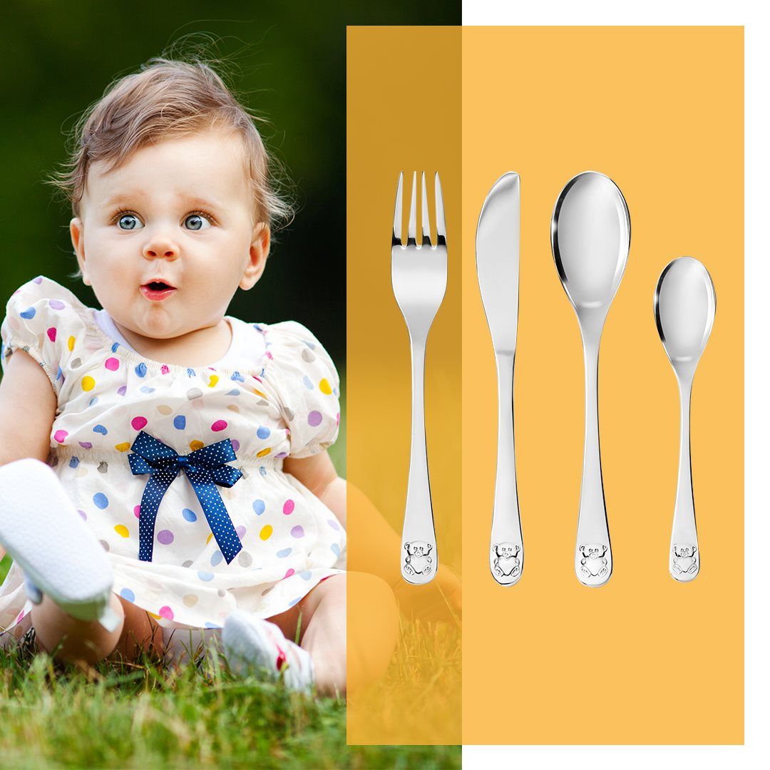 baby met kinderbestek ernaast