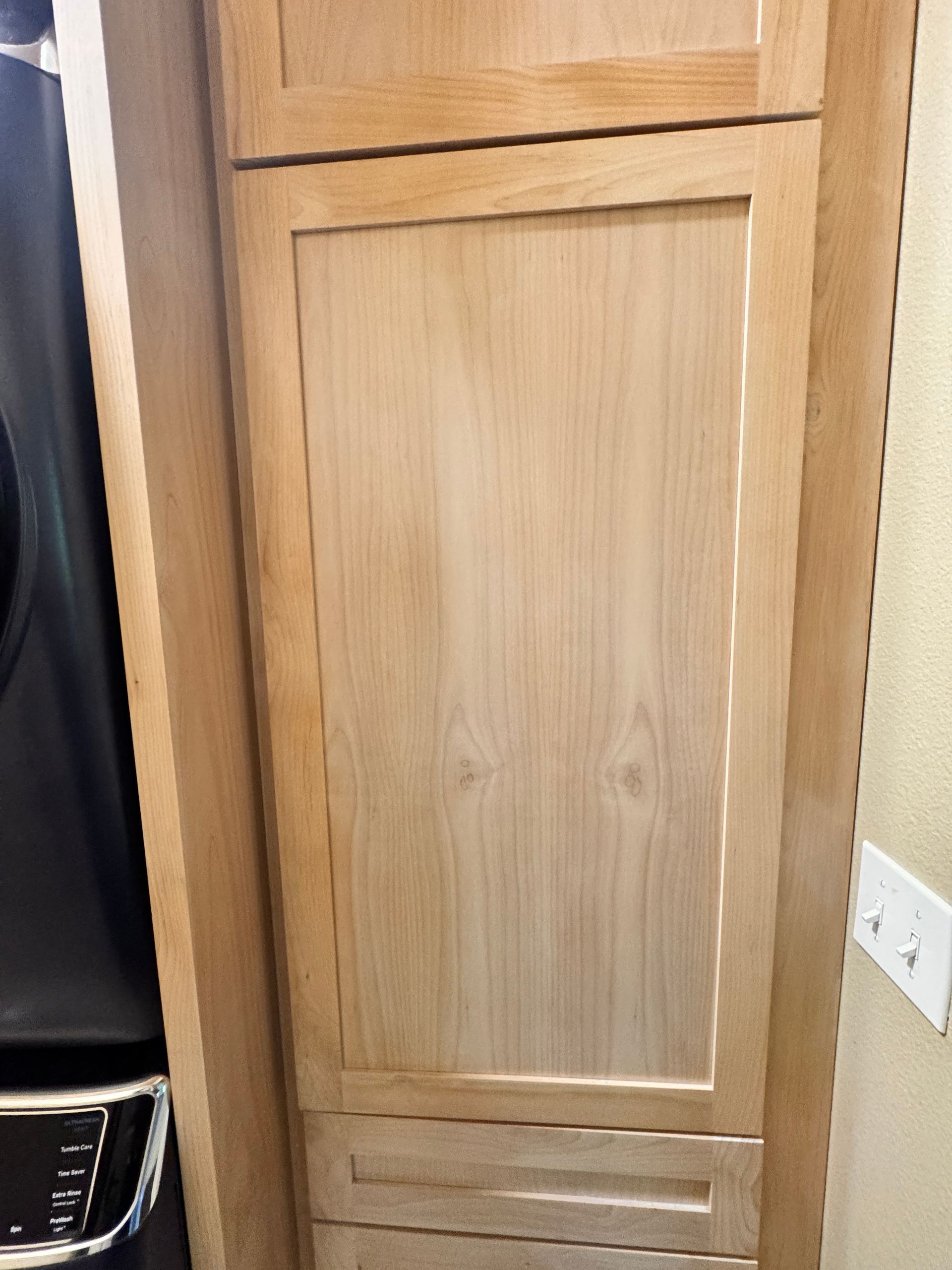 Wooden cabinet door with recessed panel in a kitchen corner