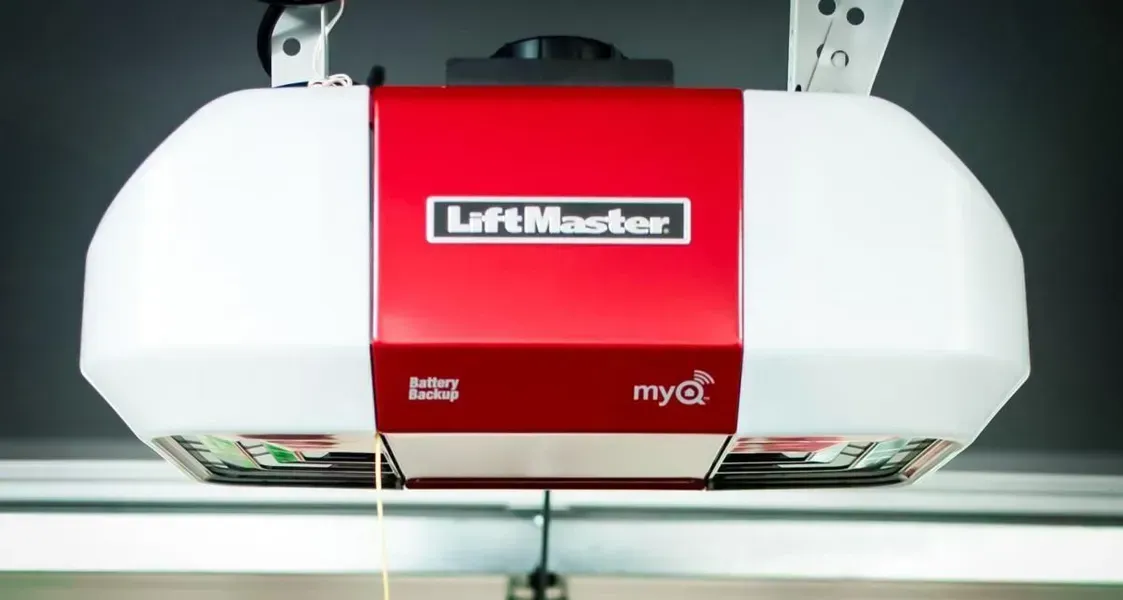 Red and white LiftMaster garage door opener mounted on the ceiling