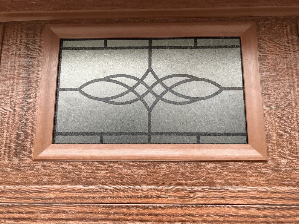 Decorative frosted glass window panel in a wooden front door