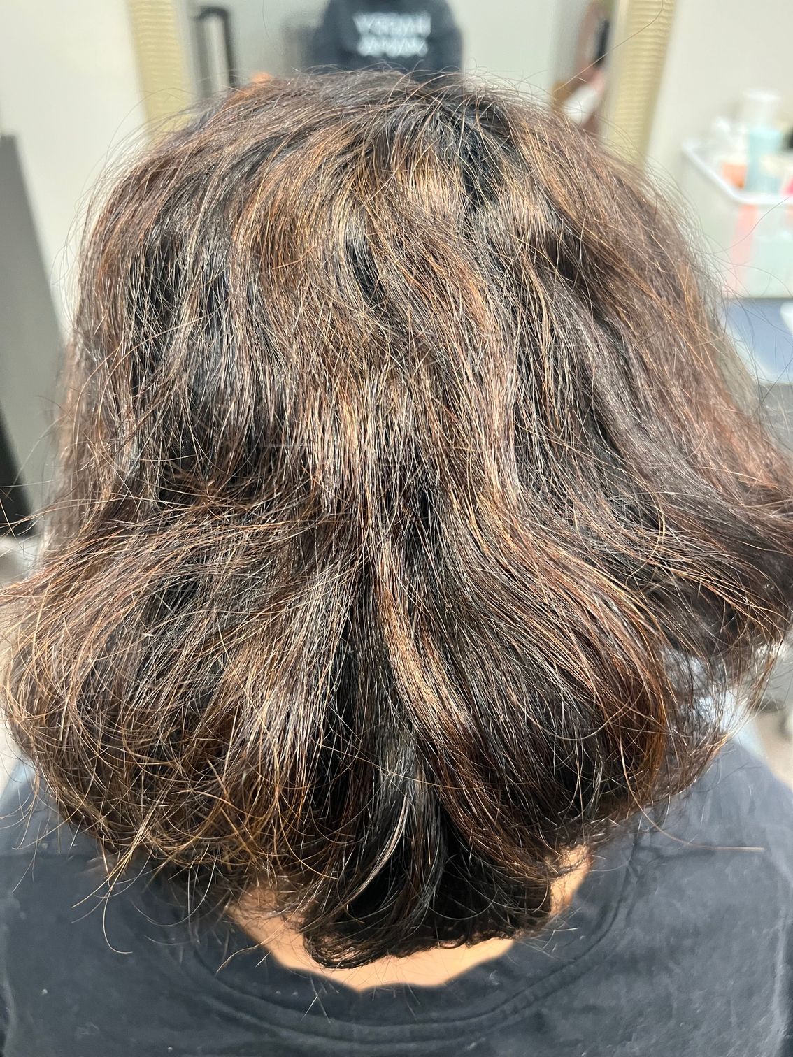 Before picture of the back of woman's head  before hair extensions.