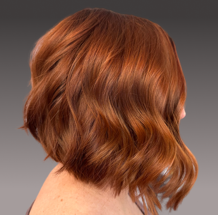 Side view of a beautiful haircut of a blond short-haired woman.