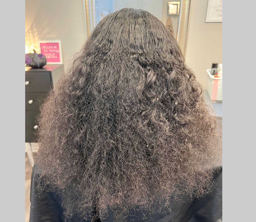 Long frizzy black hair. It is very thick and fluffy.