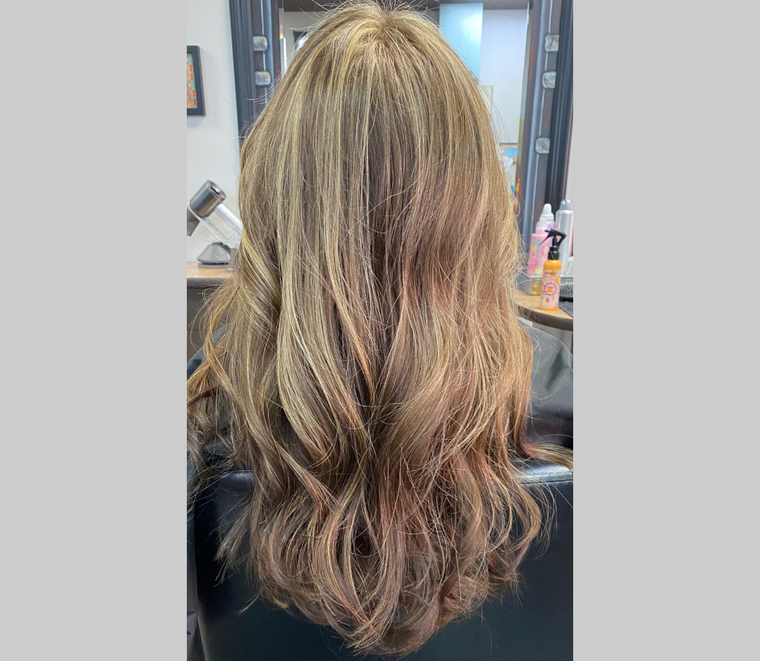 Beautiful long blond hair with soft pink highlights.