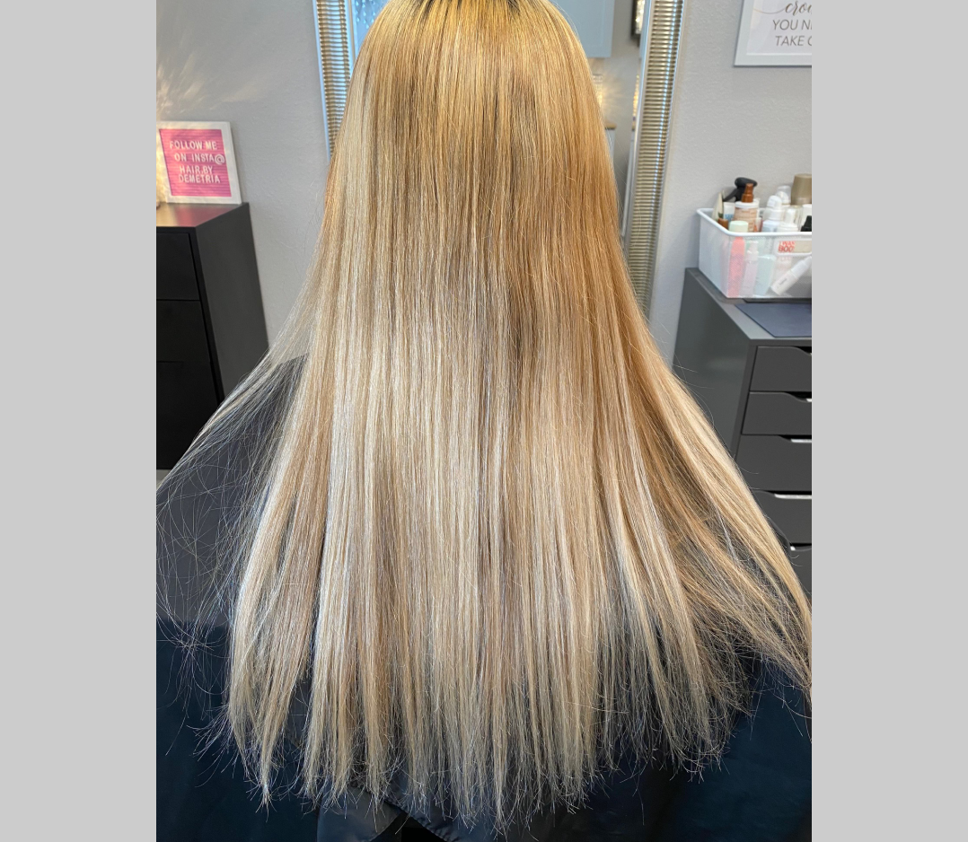 Before picture of a woman;s hair that is long, blonde, and irregular highlights.