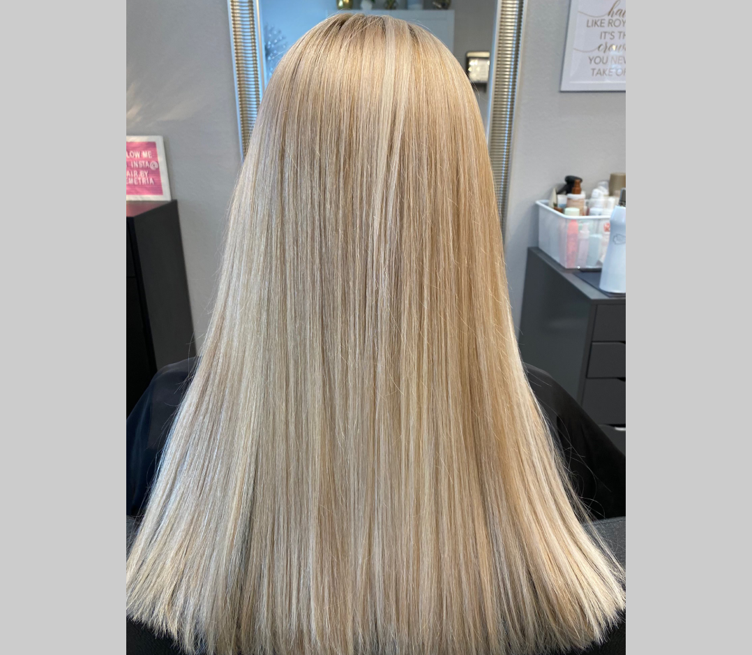 After picture of a woman's hair that looks long, smooth, and blonde.