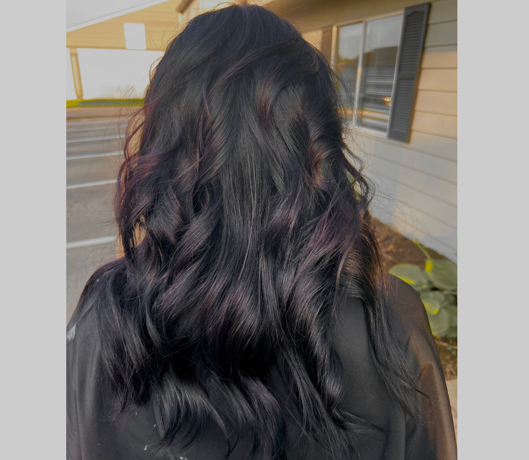 After picture of a woman's hair and it looks smooth and wavy with rich color.