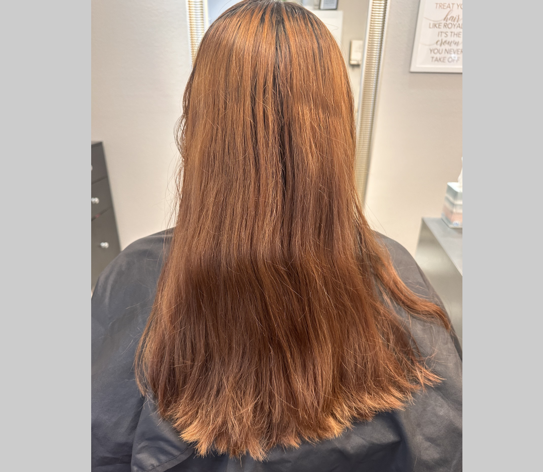 Before picture of a woman with long red hair.
