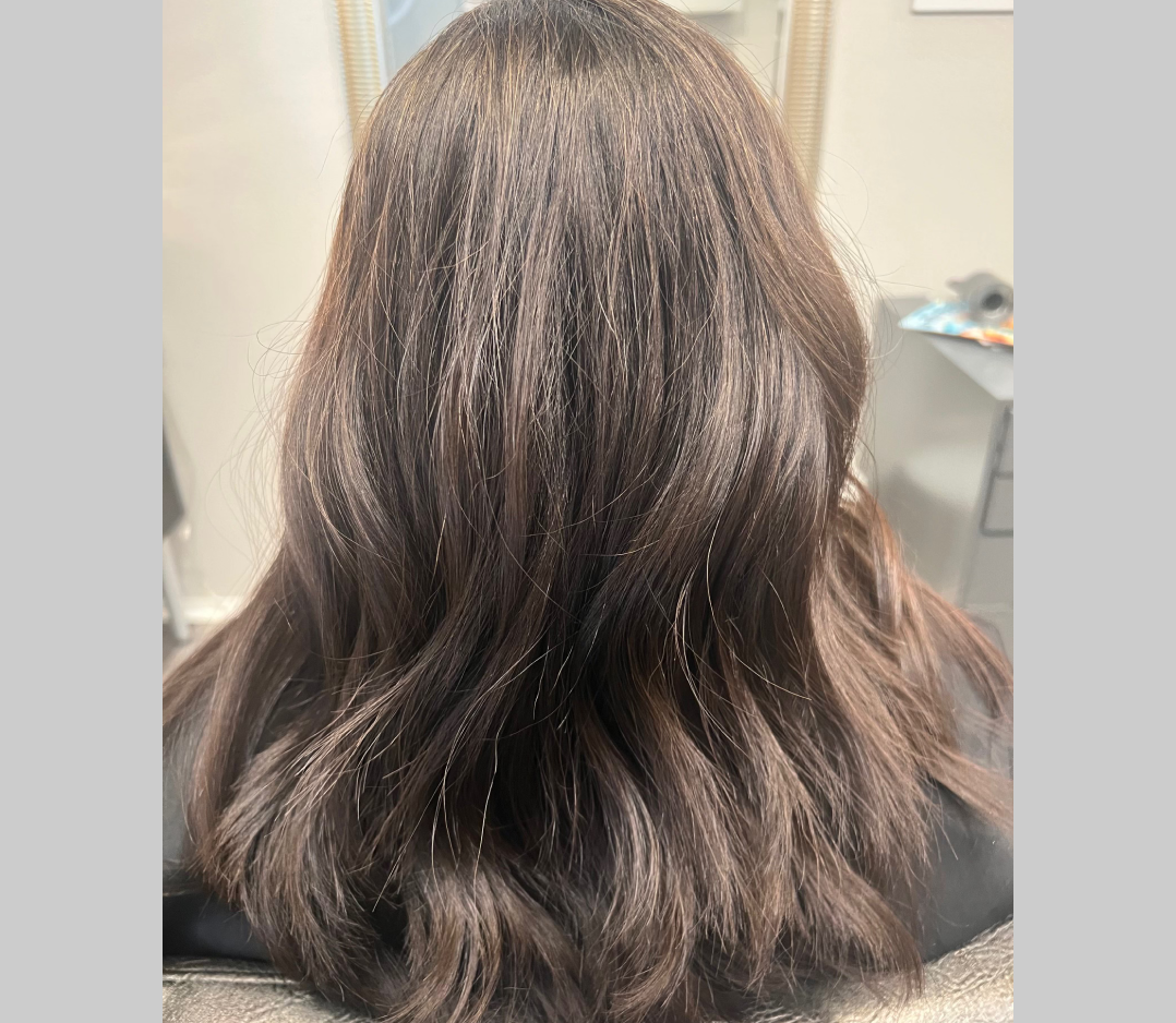 After picture of a woman's hair and it looks smooth and wavy.