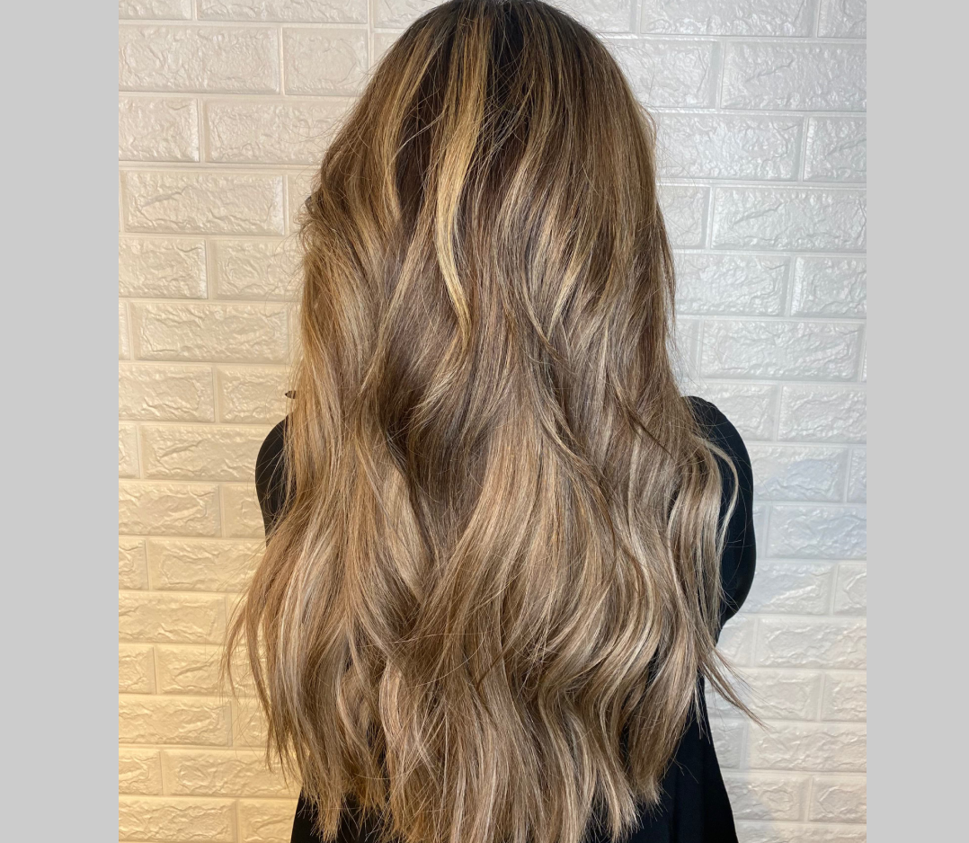 After picture of a woman's hair with thick full extensions.