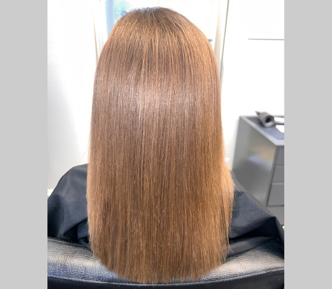 After picture of a woman and her hair is now soft and straight and shiny.