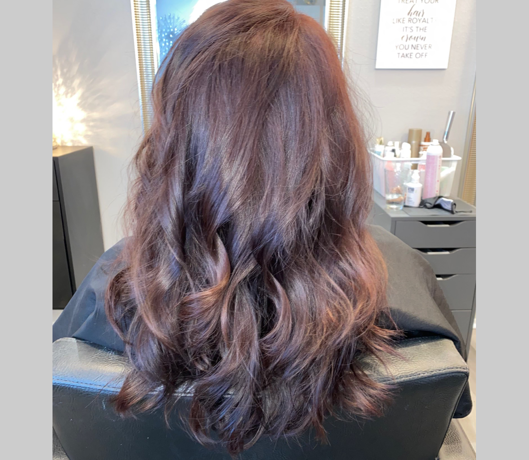 After picture of a woman's hair and it is long, smooth, and wavy.
