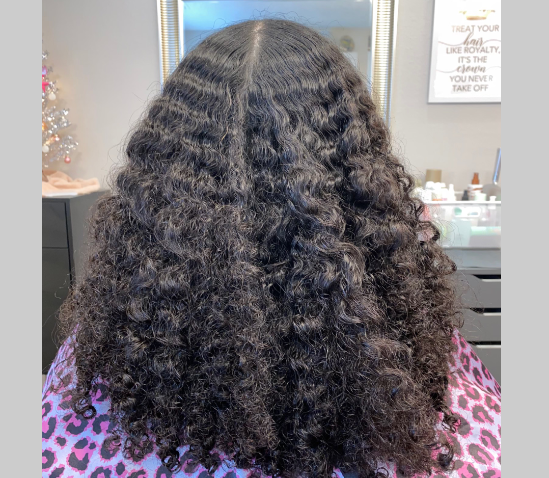 Before picture of a woman's hair that is very curly.