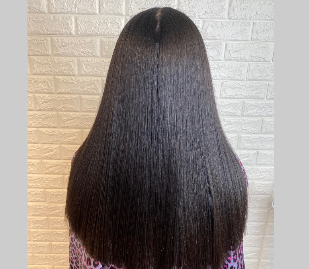 After picture of a woman's hair than is now smooth, straight, and shiny.