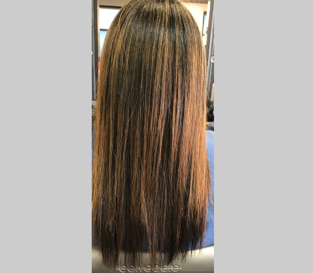 After picture of a woman's hair that is smooth and shiny.