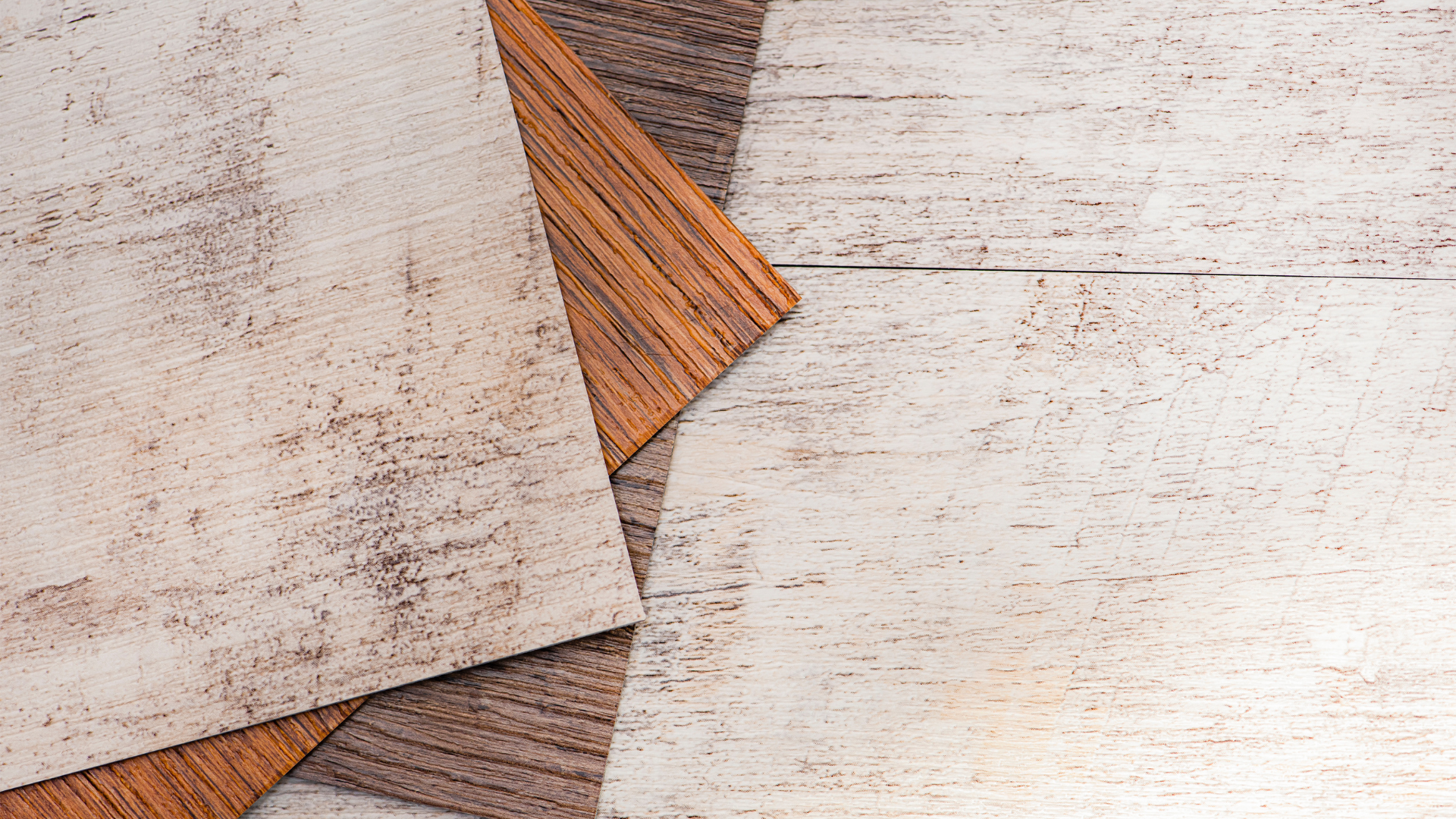 Three pieces of wood are stacked on top of each other on a wooden table.