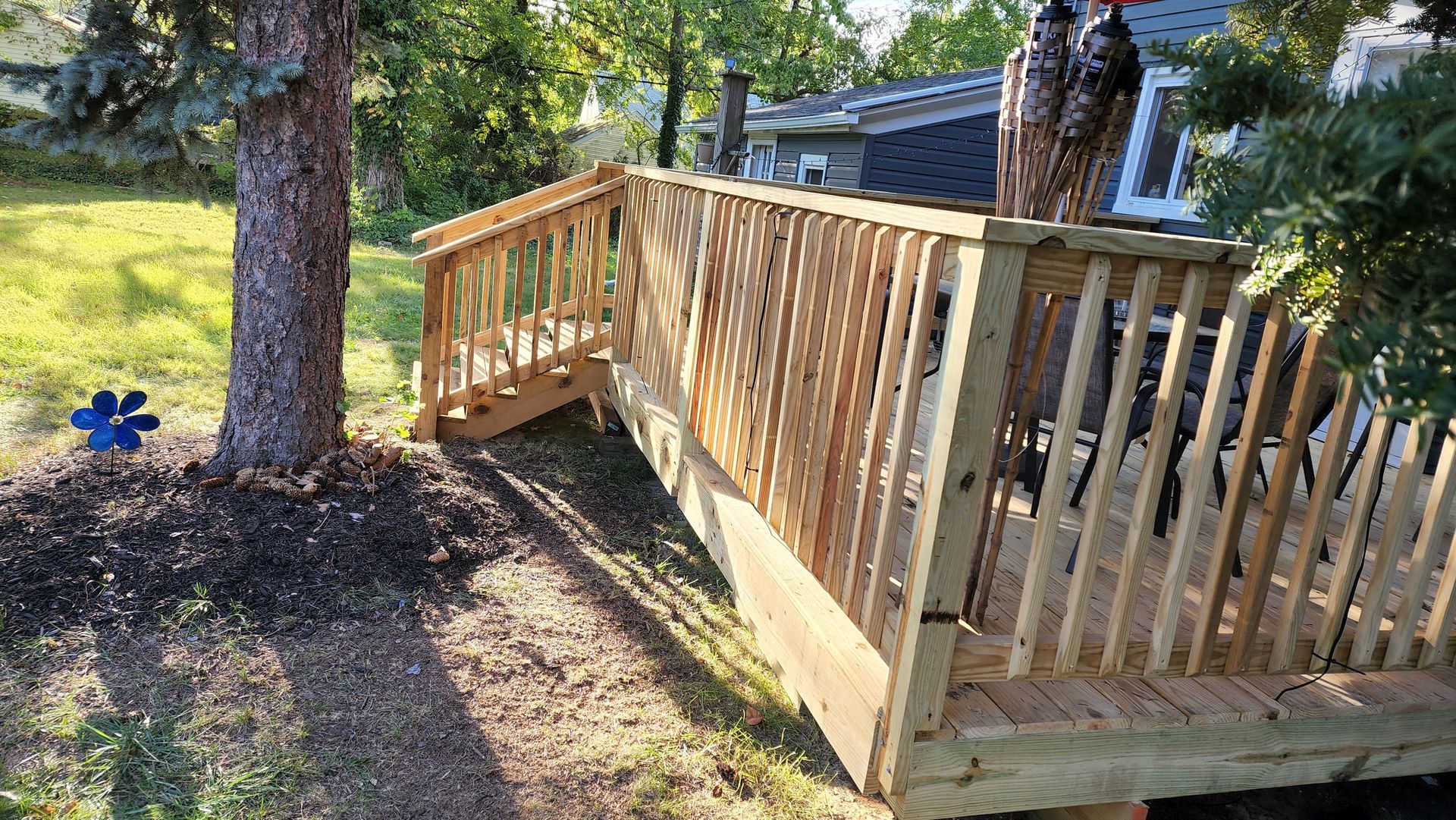 a wooden deck with stairs leading up to a door