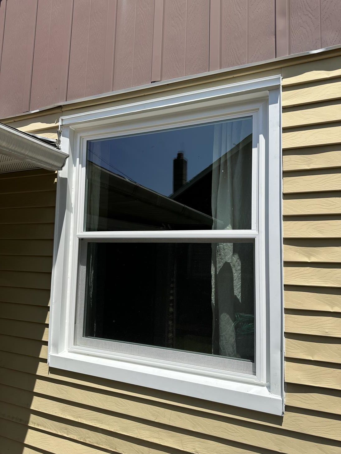 A man is installing a window in a house.
