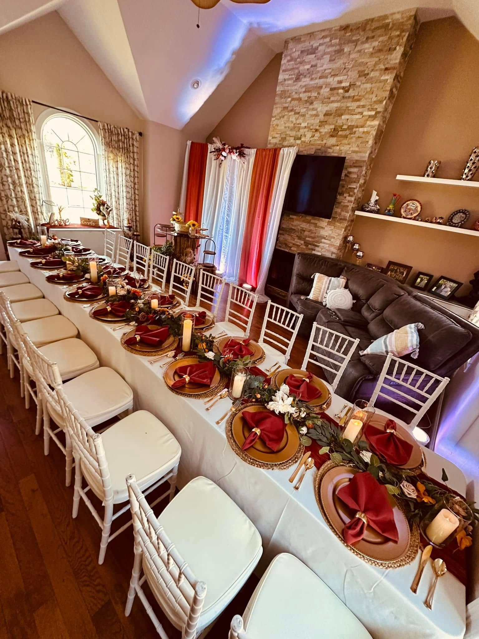 A long table with plates and napkins on it in a living room.