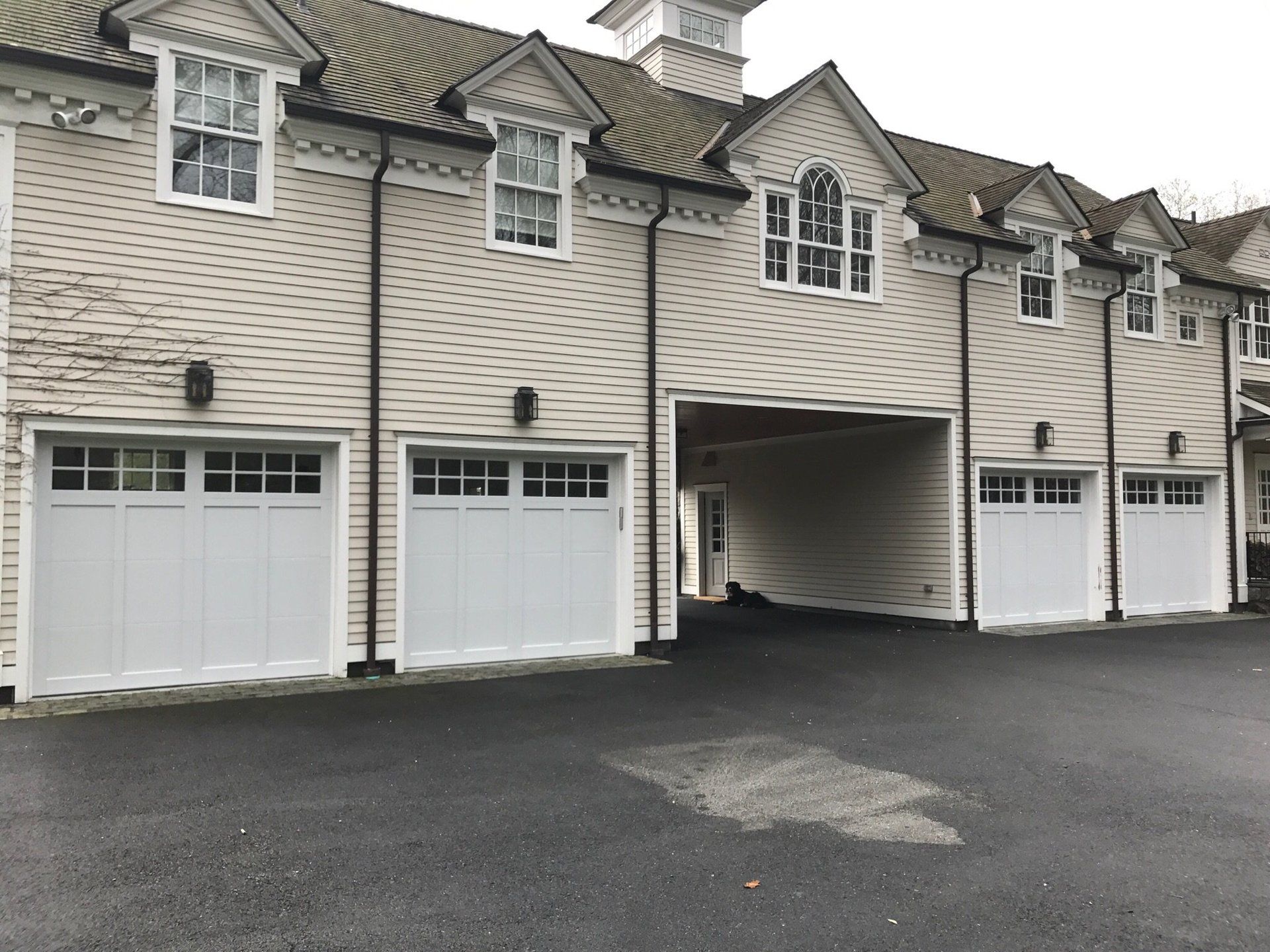 four identical garage doors in wide building