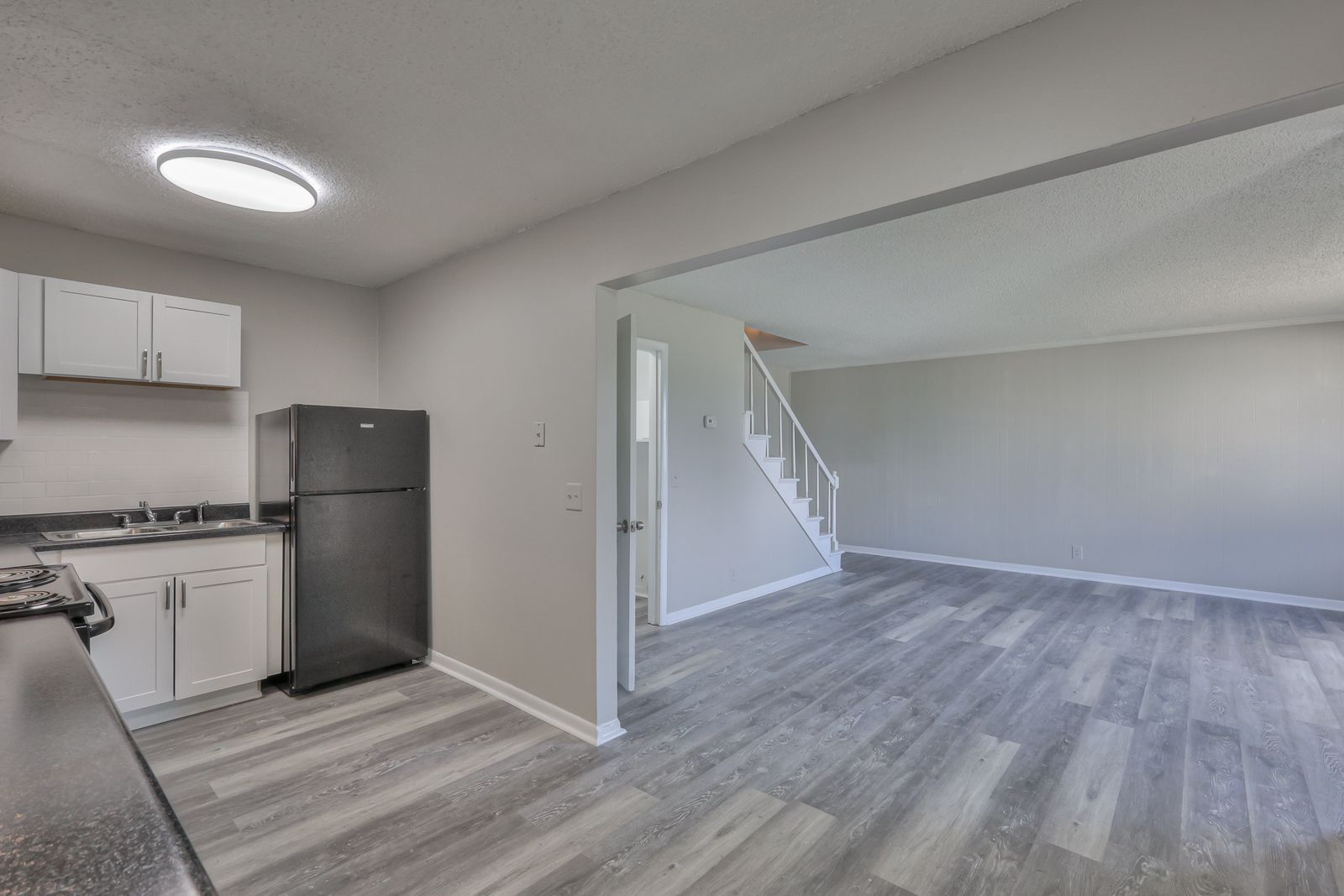 Photo of a kitchen, showing the open entrance to the living room