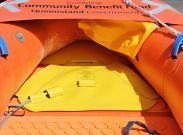 Bright orange inflatable shelter interior with a yellow floor and blue straps.